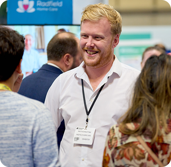 exhibitor man smiling to visitors